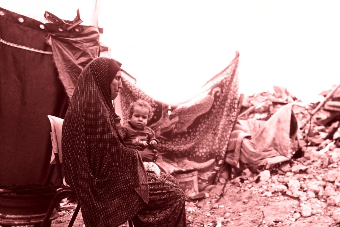 A group of young palestinians ride on the back of a truck to escape north of Gaza